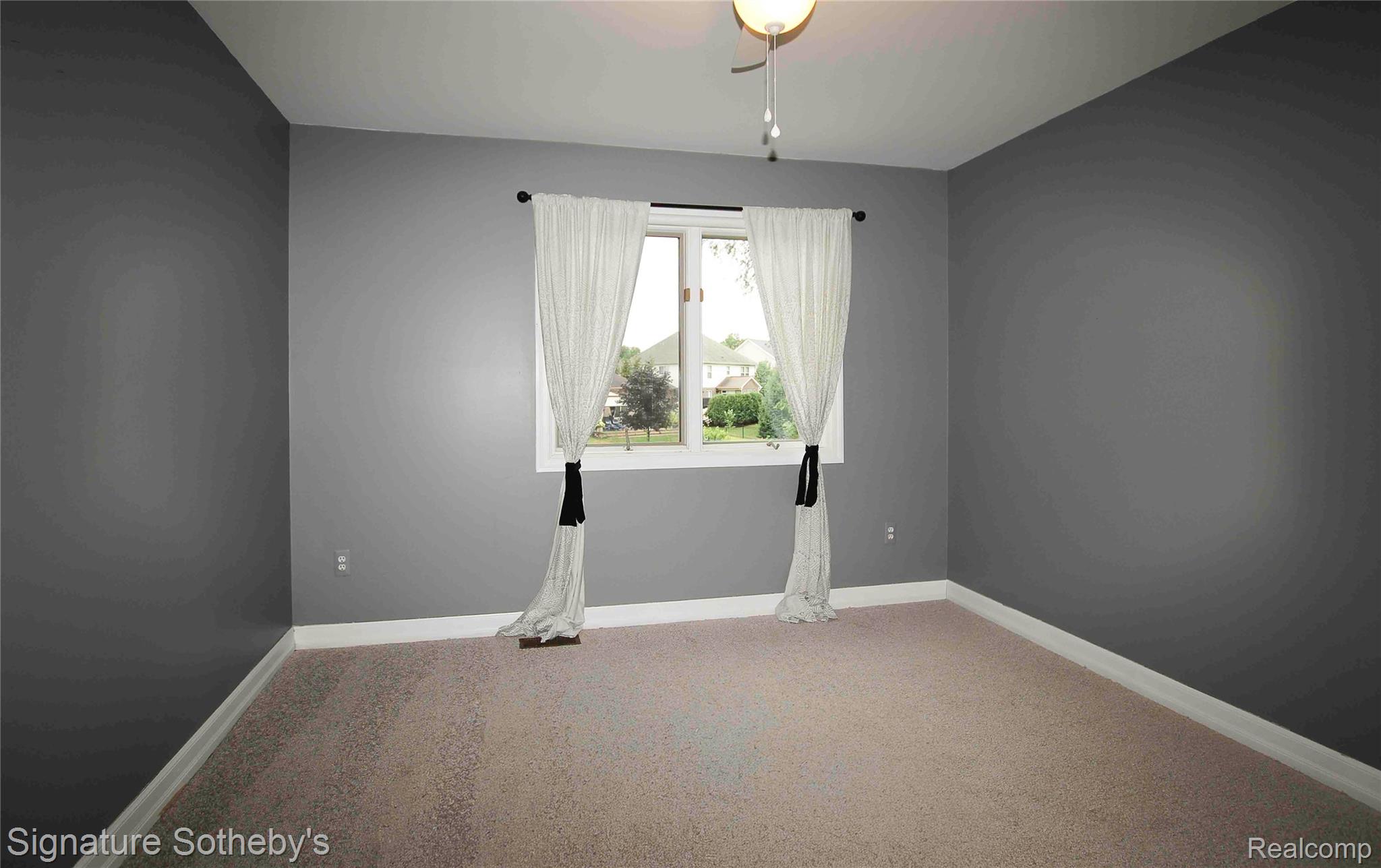 3131 Smugglers Ridge Walled Lake, MI 48390 - Photo 23 of 35 Neutral-toned carpeting and gray painted walls