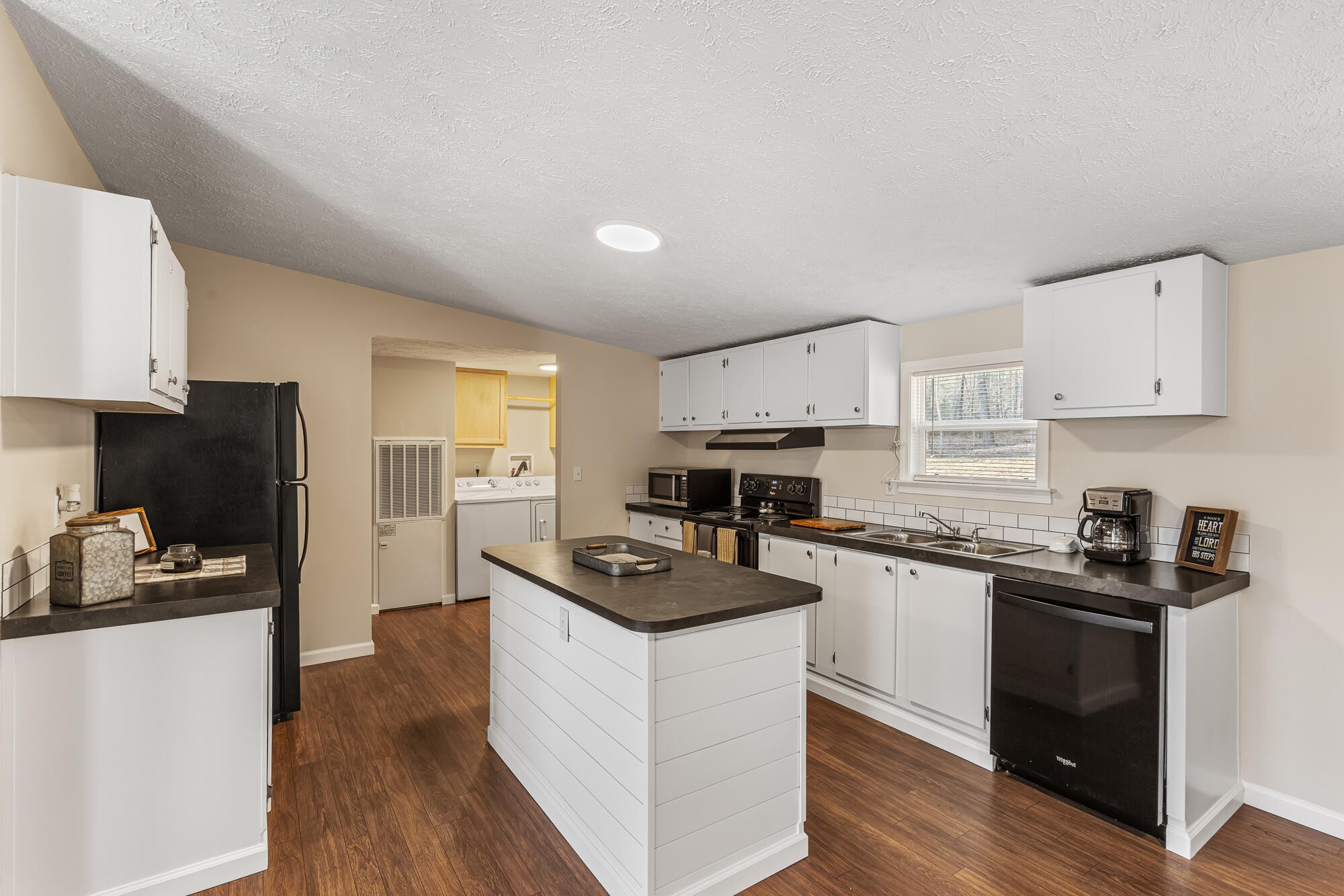 185 Bivens Road Tellico Plains, TN 37385 - Photo 16 of 34 a kitchen with white cabinets and appliances