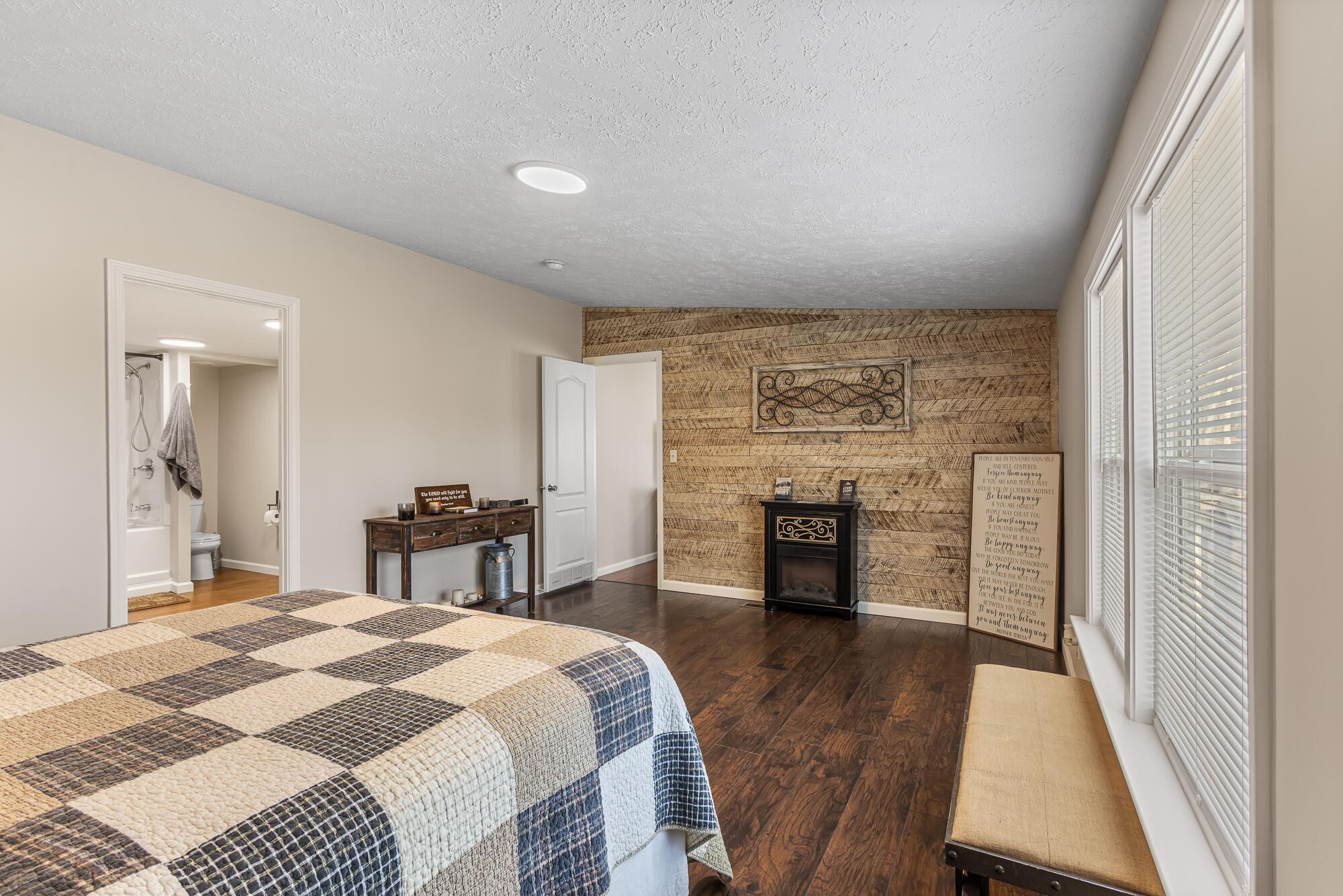 185 Bivens Road Tellico Plains, TN 37385 - Photo 23 of 34 a spacious bedroom with a bed and fireplace