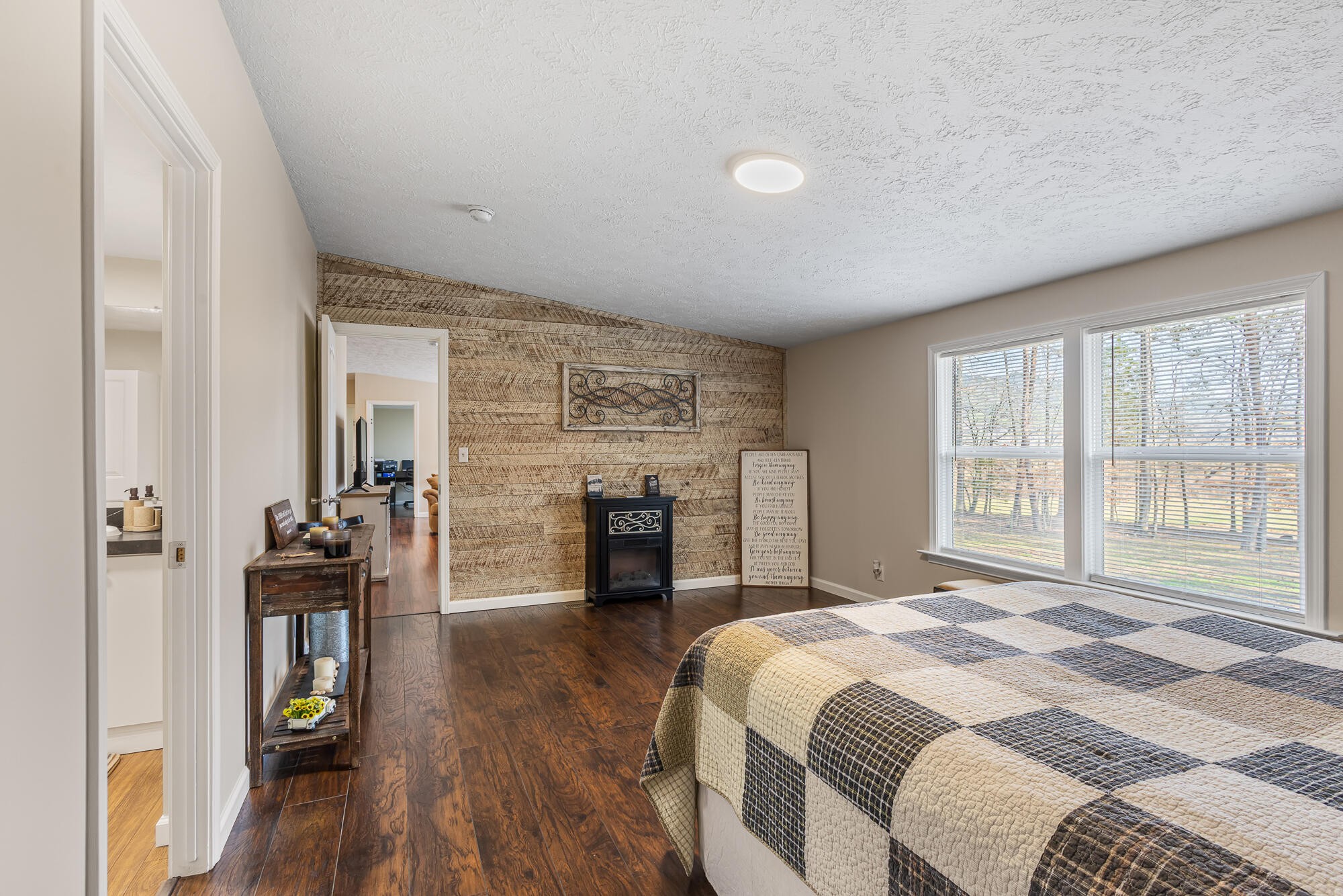 185 Bivens Road Tellico Plains, TN 37385 - Photo 25 of 34 a bedroom with a bed and a flat tv screen on the dresser