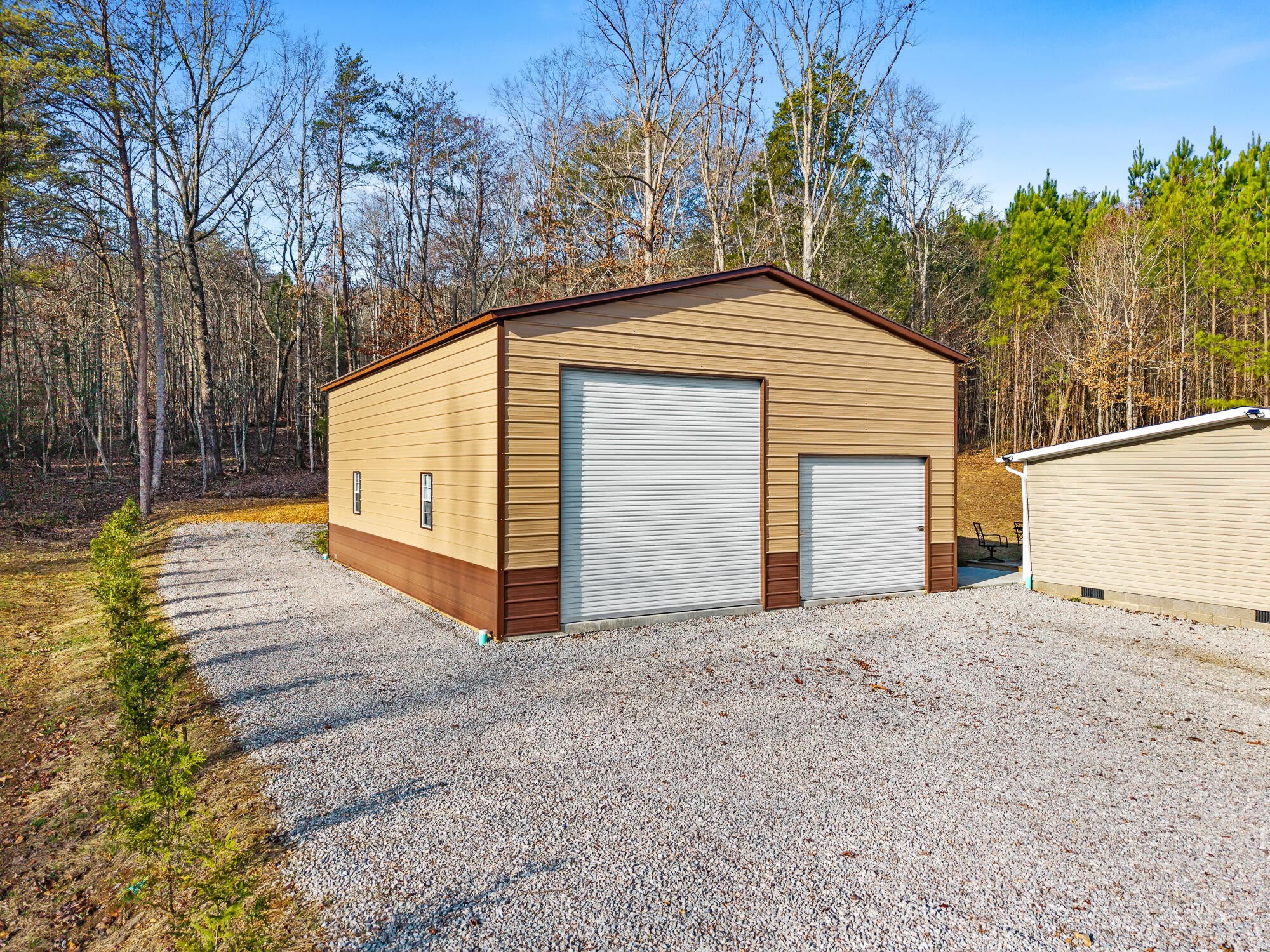 185 Bivens Road Tellico Plains, TN 37385 - Photo 5 of 34 a backyard of a house with garage and yard