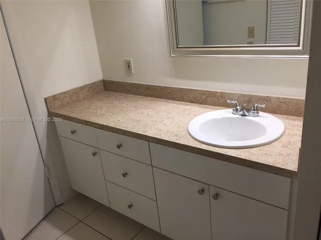 a bath tub sitting next to a white sink