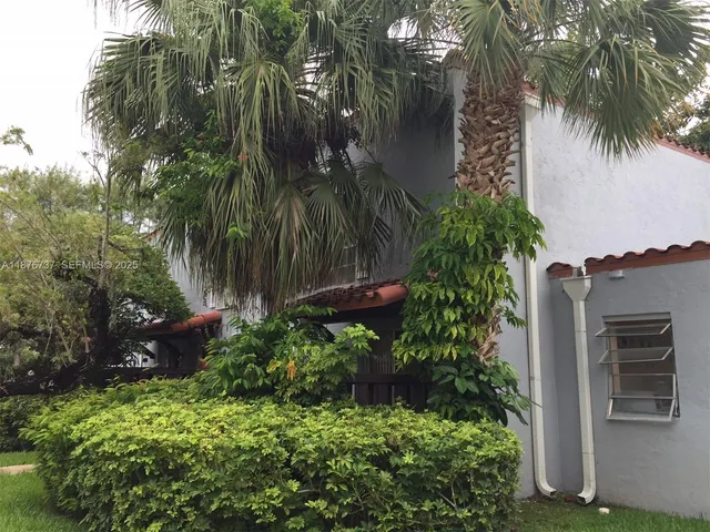 a backyard of a house with barbeque oven and outdoor seating