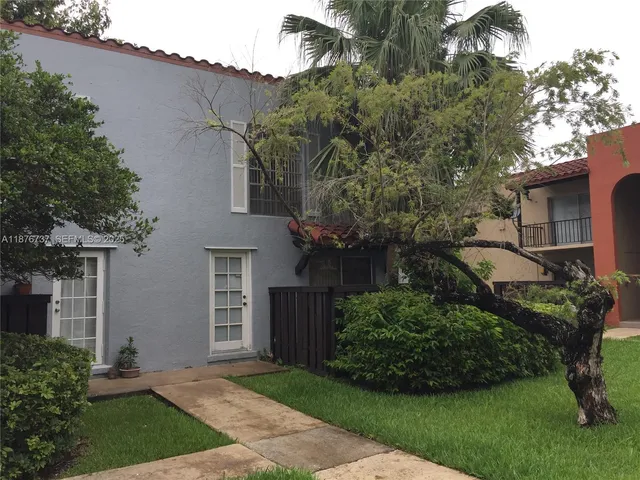 a view of a house with a yard and plants