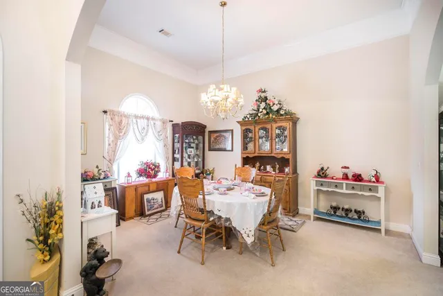 a living room with furniture a rug and white walls