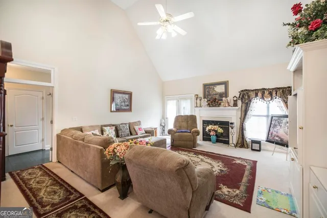 a living room with furniture large window and flat screen tv