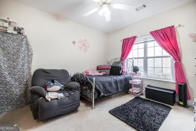 a bathroom with a sink a toilet and a shower curtain