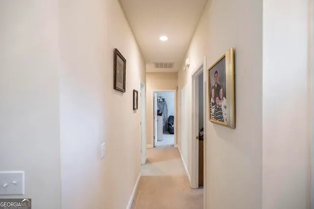 a bedroom with a bed a chandelier and a flat screen tv