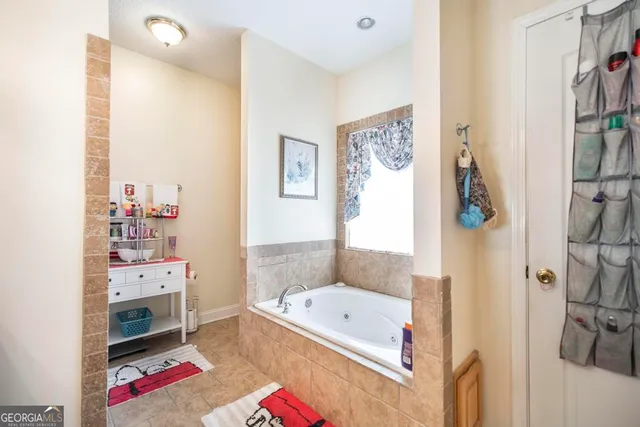 a kitchen with stainless steel appliances granite countertop a sink a stove and a granite counter tops with a window