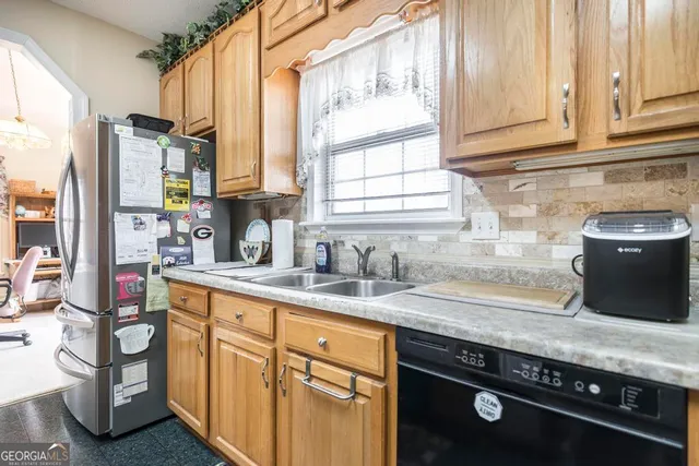 a kitchen with refrigerator a stove and a refrigerator