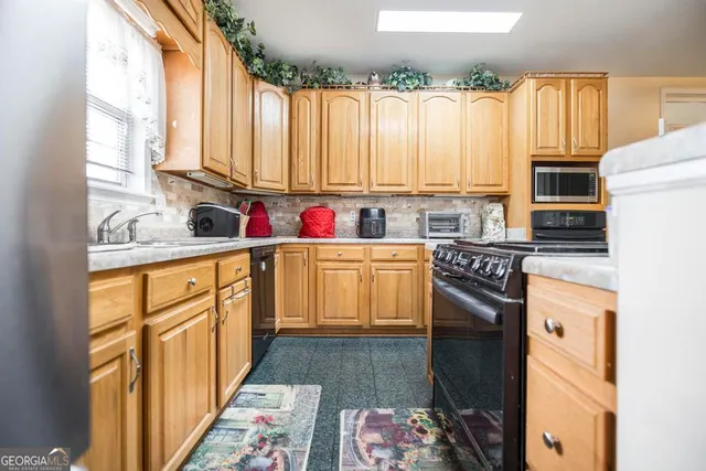 a kitchen with a sink stove top oven and cabinets