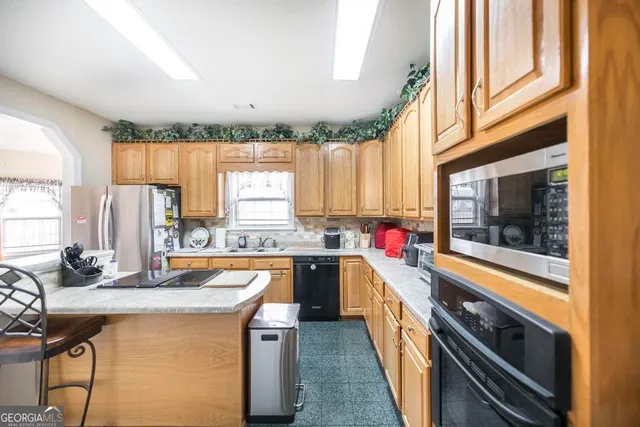 a work room with furniture a flat screen tv and a chandelier
