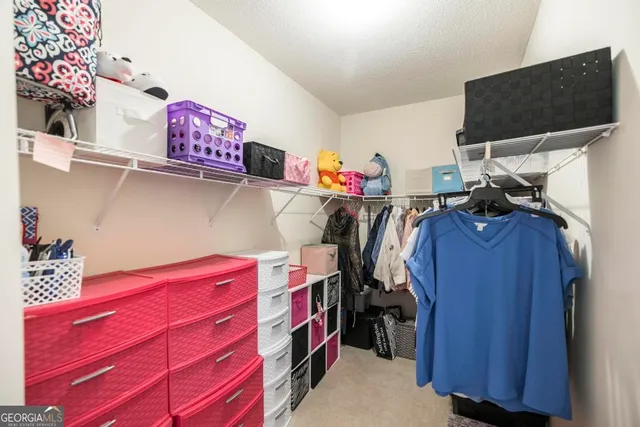 a view of a house with a yard covered with snow and trees