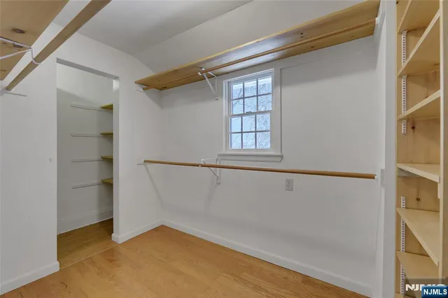 a large bed sitting in a bedroom next to a window