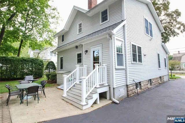 a view of a house with a yard and garage
