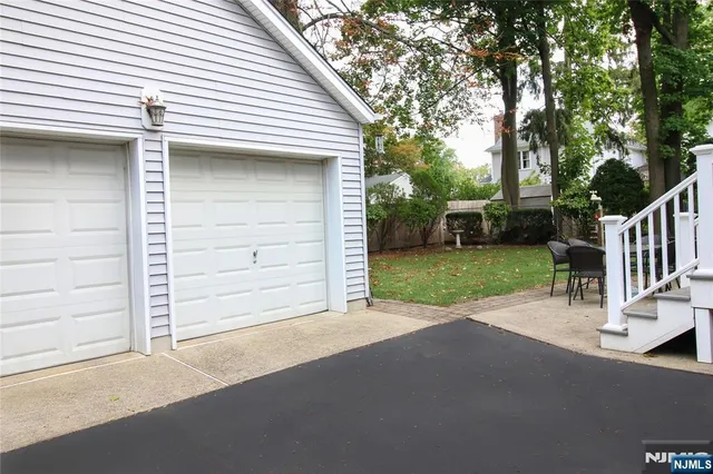 a backyard of a house with table and chairs