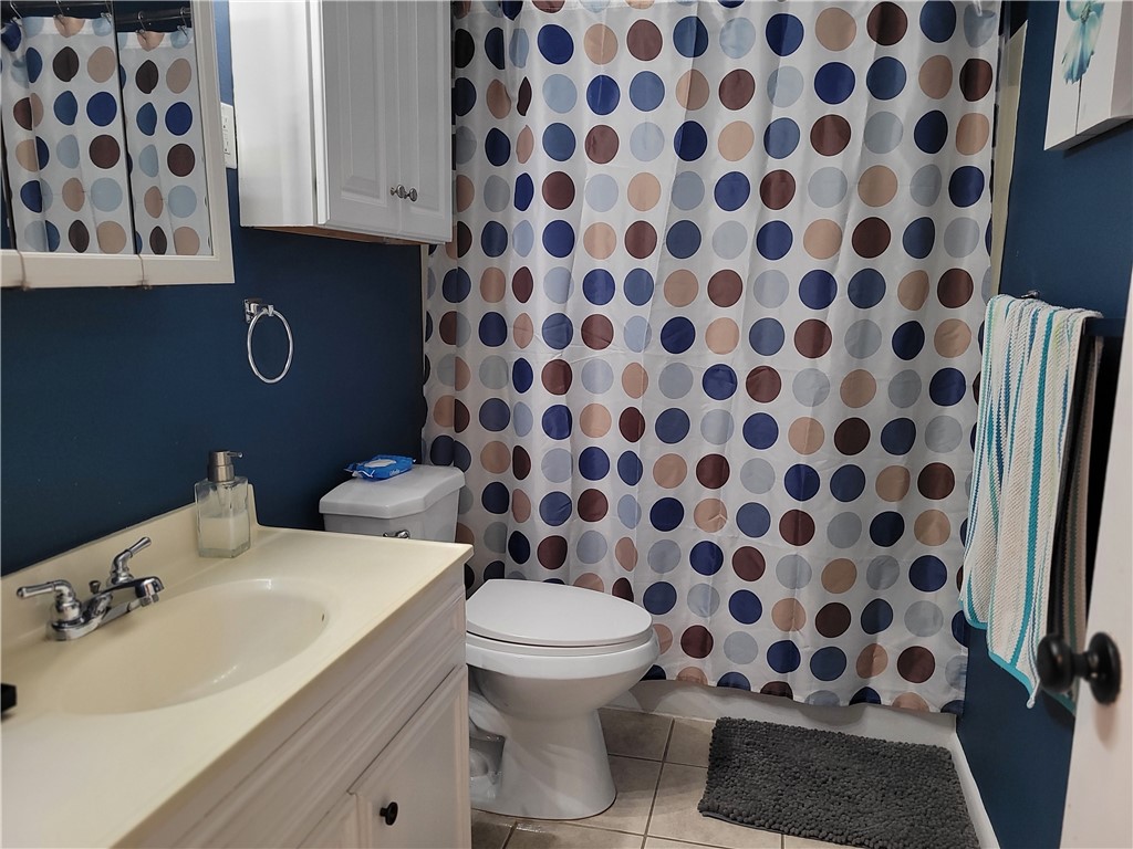 4902 Marion Circle Corpus Christi, TX 78411 - Photo 13 of 27 a bathroom with a sink and mirror with toilet