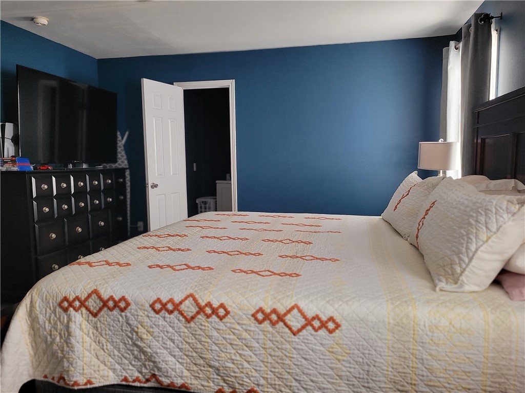 4902 Marion Circle Corpus Christi, TX 78411 - Photo 16 of 27 a bedroom with a bed and a flat screen tv
