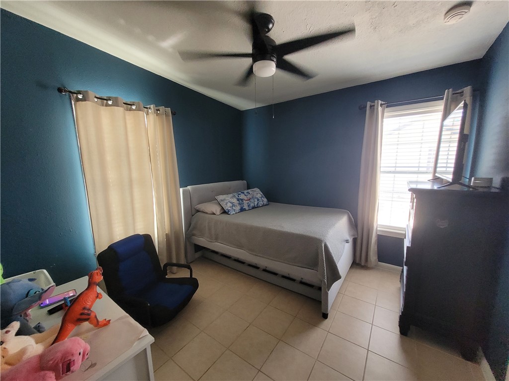 4902 Marion Circle Corpus Christi, TX 78411 - Photo 18 of 27 a bedroom with a bed and window
