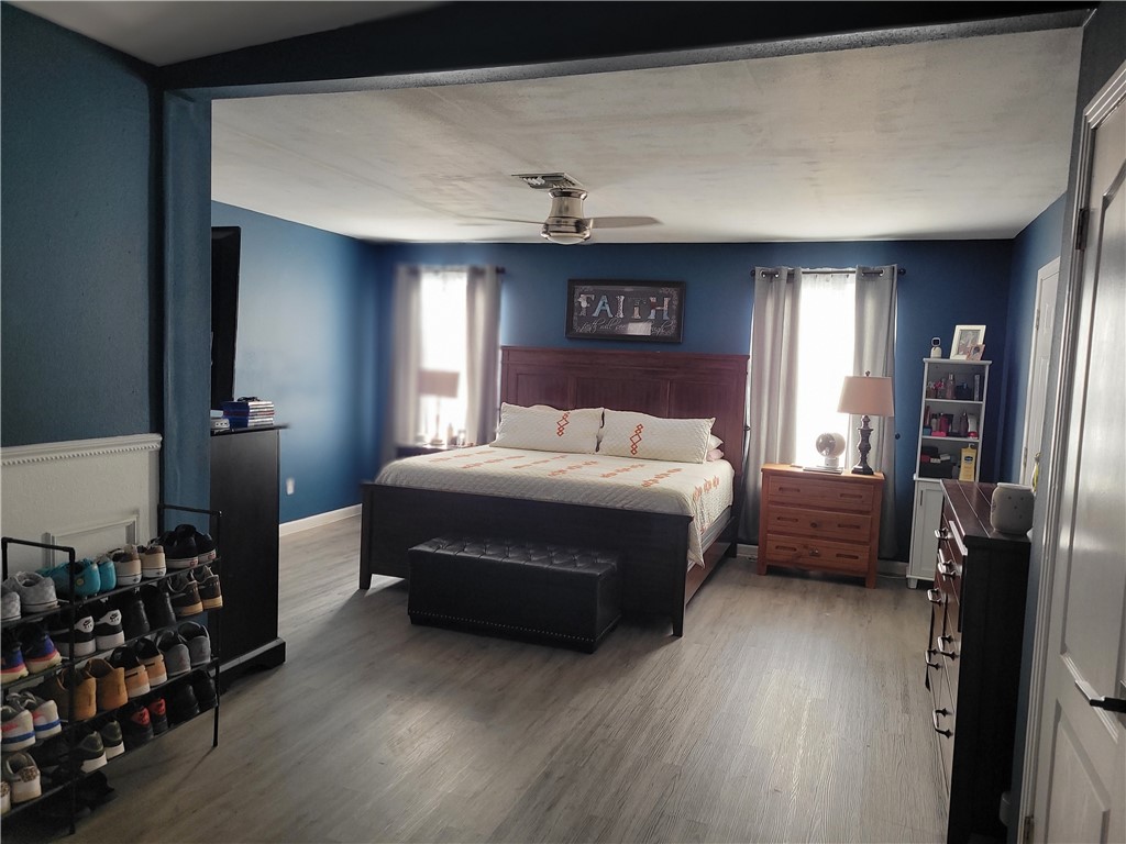 4902 Marion Circle Corpus Christi, TX 78411 - Photo 20 of 27 a bedroom with a bed and a chandelier