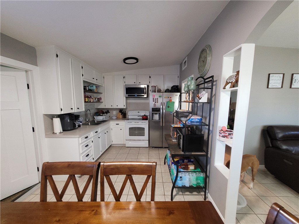 4902 Marion Circle Corpus Christi, TX 78411 - Photo 2 of 27 a kitchen with stainless steel appliances wooden floor and refrigerator
