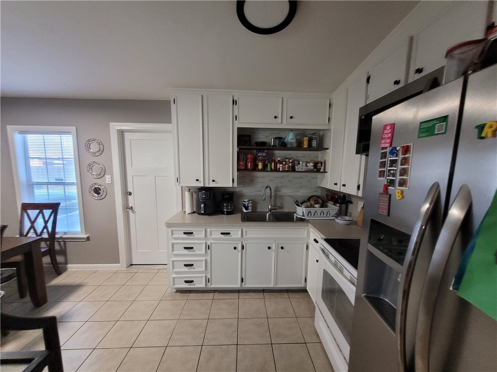 4902 Marion Circle Corpus Christi, TX 78411 - Photo 4 of 27 a kitchen with stainless steel appliances a stove a sink a microwave a refrigerator and cabinets
