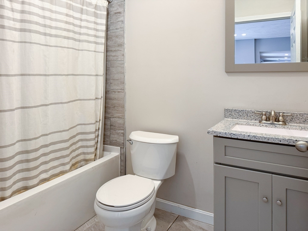 1 Chapel Lane Wareham, MA 02538 - Photo 17 of 29 a bathroom with a granite countertop toilet a sink and a mirror