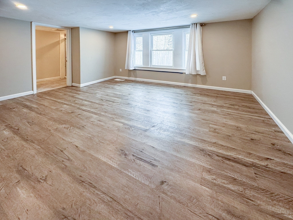 1 Chapel Lane Wareham, MA 02538 - Photo 20 of 29 an empty room with wooden floor and windows