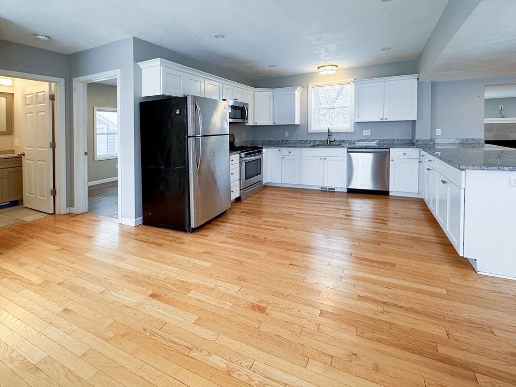 1 Chapel Lane Wareham, MA 02538 - Photo 8 of 29 a large kitchen with stainless steel appliances granite countertop a refrigerator and a stove top oven