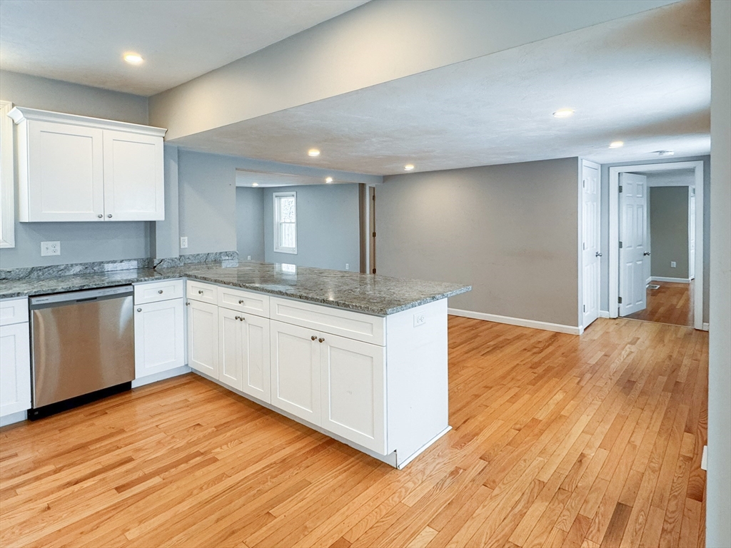 1 Chapel Lane Wareham, MA 02538 - Photo 9 of 29 a large kitchen with stainless steel appliances granite countertop a white stove top oven and white cabinets