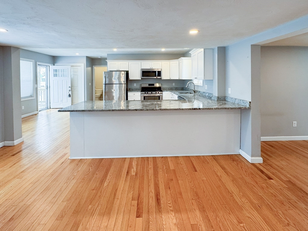 1 Chapel Lane Wareham, MA 02538 - Photo 10 of 29 a view of kitchen with granite countertop cabinets and wooden floor