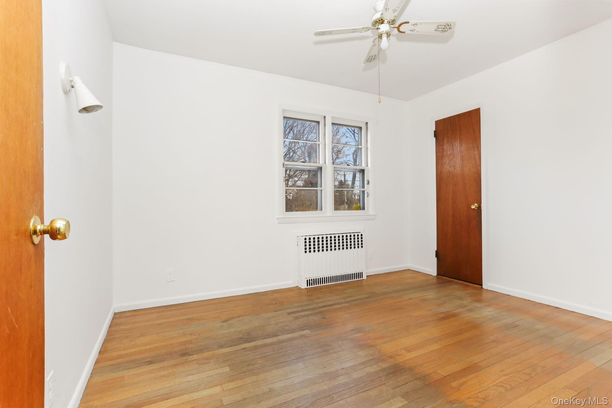 3 Hill Street New Rochelle, NY 10801 - Photo 18 of 46 a view of an empty room with wooden floor and a window