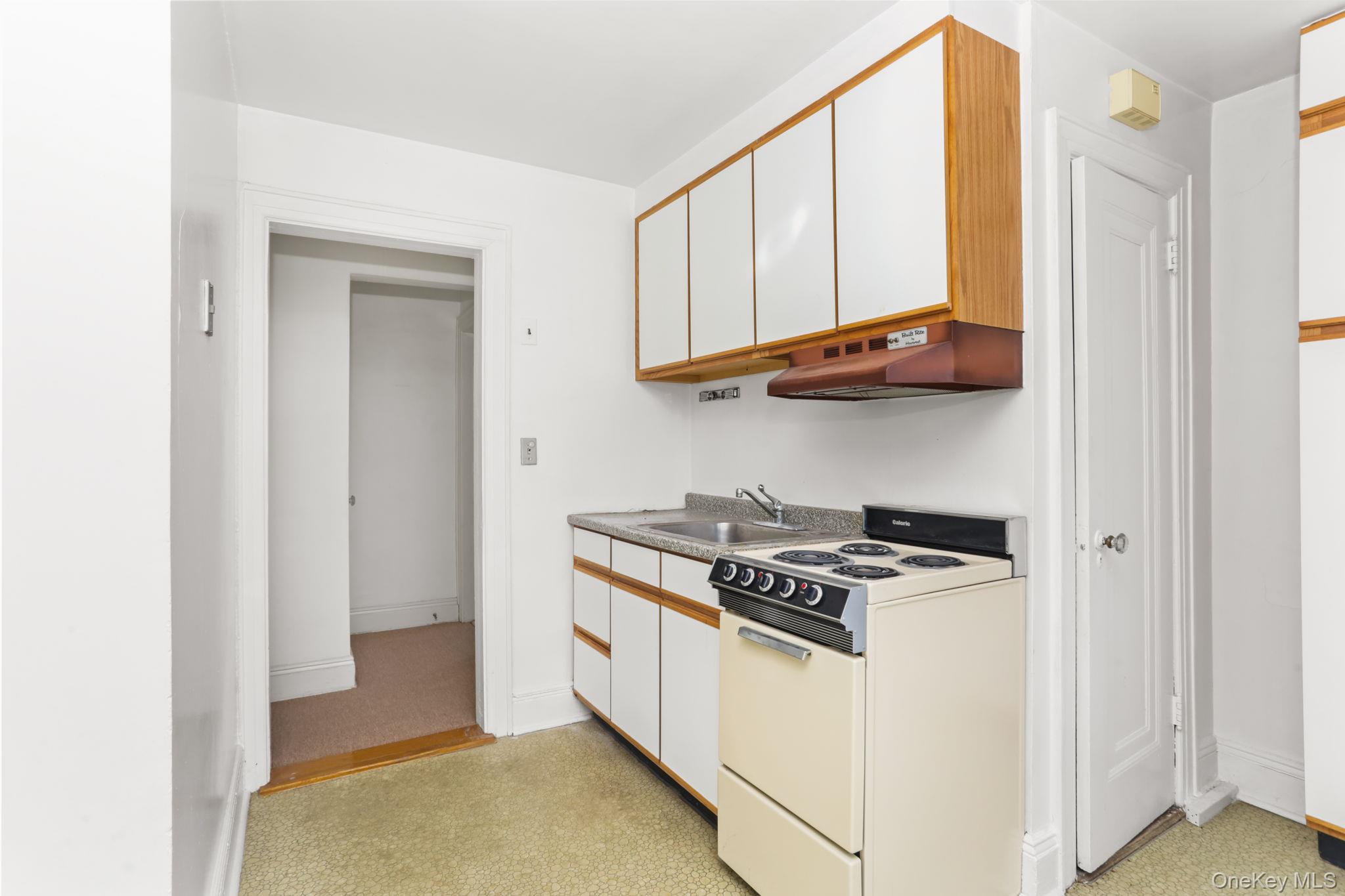 3 Hill Street New Rochelle, NY 10801 - Photo 21 of 46 a kitchen with stainless steel appliances granite countertop a stove and a refrigerator