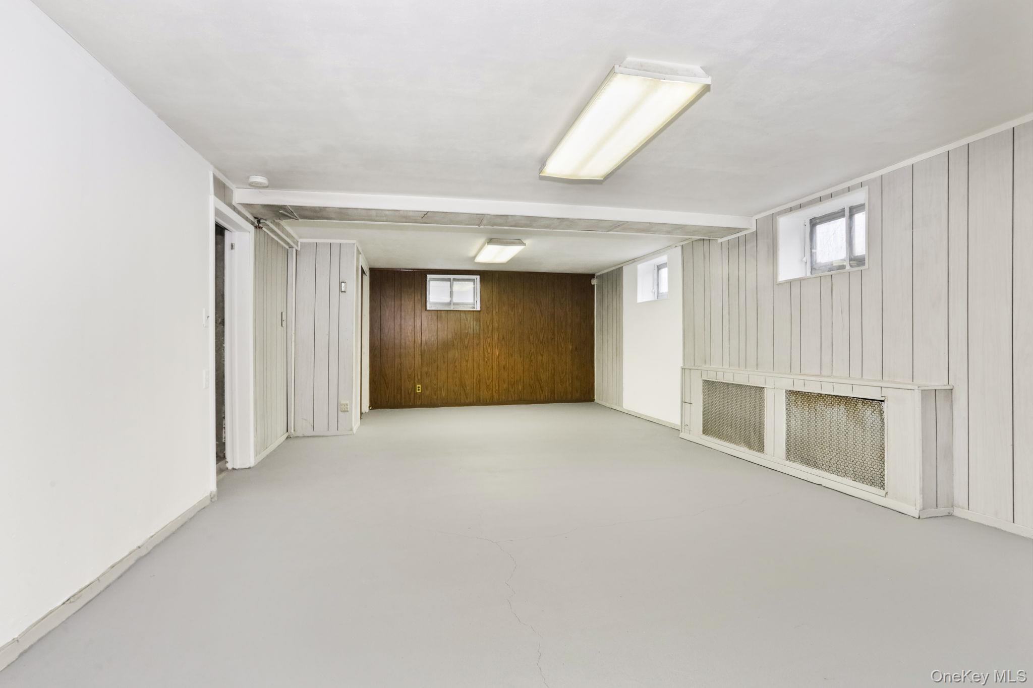 3 Hill Street New Rochelle, NY 10801 - Photo 35 of 46 a view of an empty room with a fireplace and a window