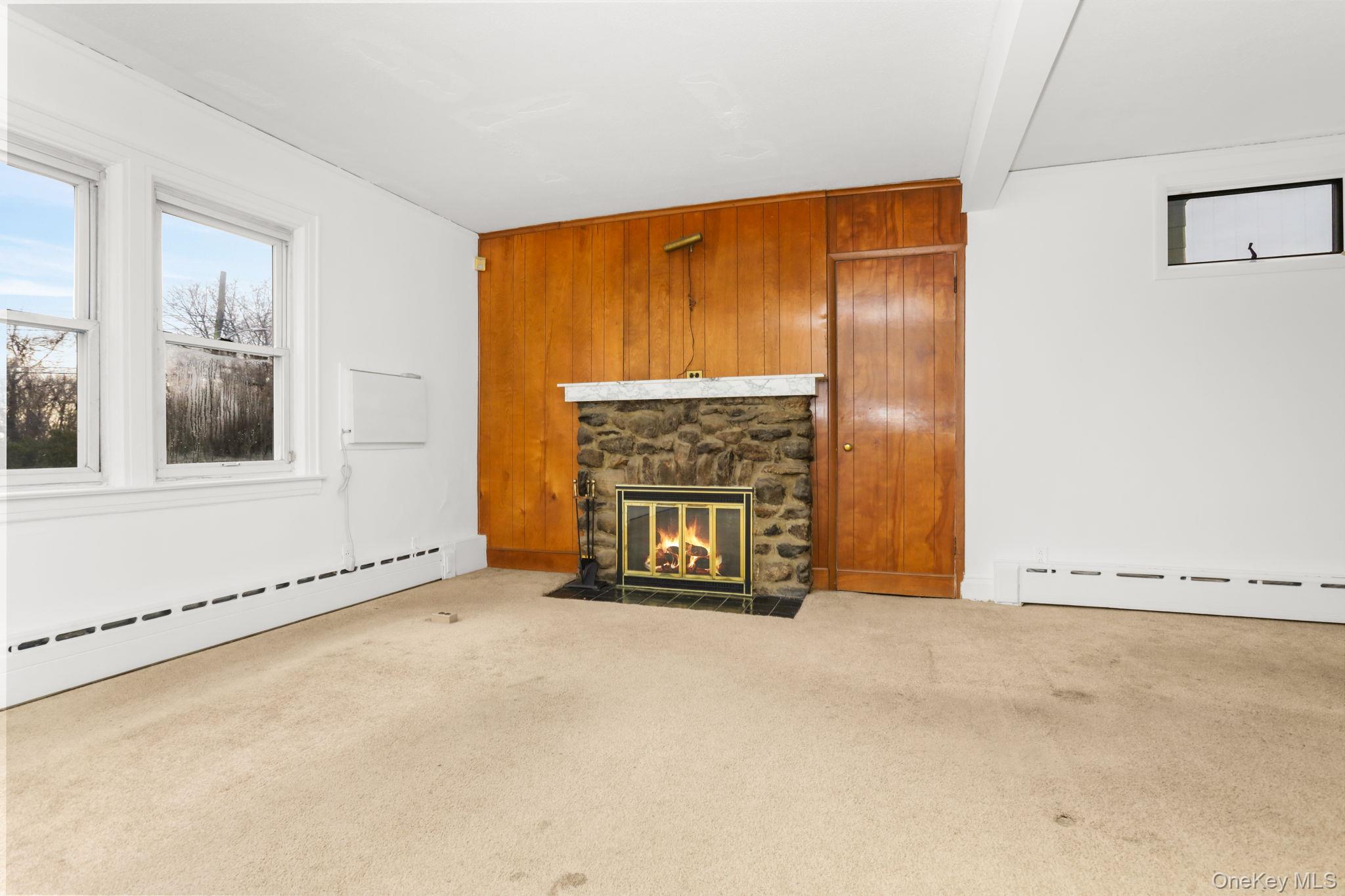 3 Hill Street New Rochelle, NY 10801 - Photo 4 of 46 an empty room with a fireplace and windows