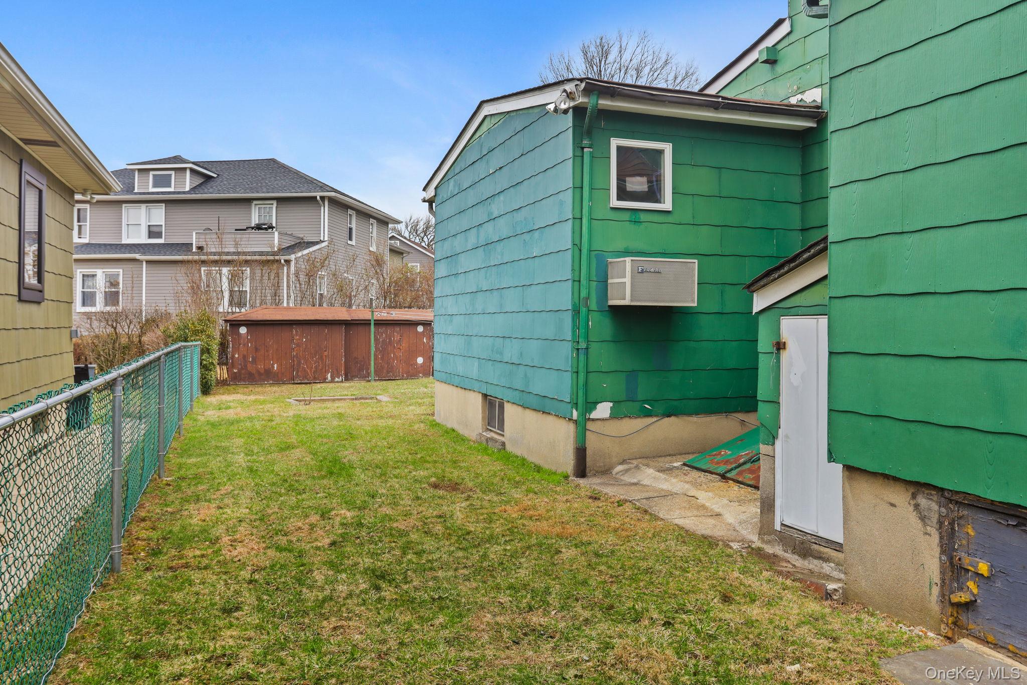 3 Hill Street New Rochelle, NY 10801 - Photo 42 of 46 a front view of a house with a yard