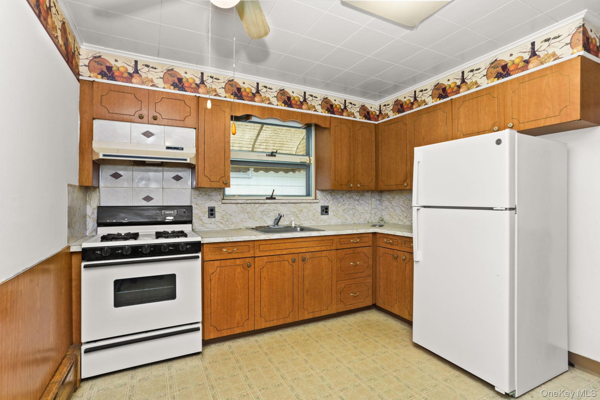 3 Hill Street New Rochelle, NY 10801 - Photo 10 of 46 a kitchen with stainless steel appliances granite countertop a refrigerator and a stove