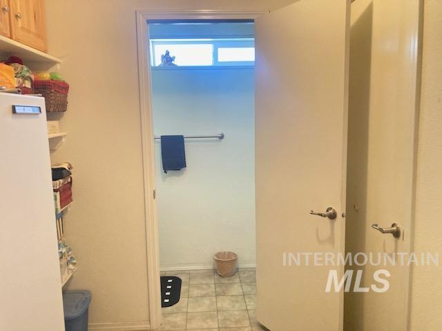 1095 County Road 70 Weiser, ID 83672 - Photo 23 of 44 Utility area with light wood-finish cabinetry, open shelving, and neutral wall paint