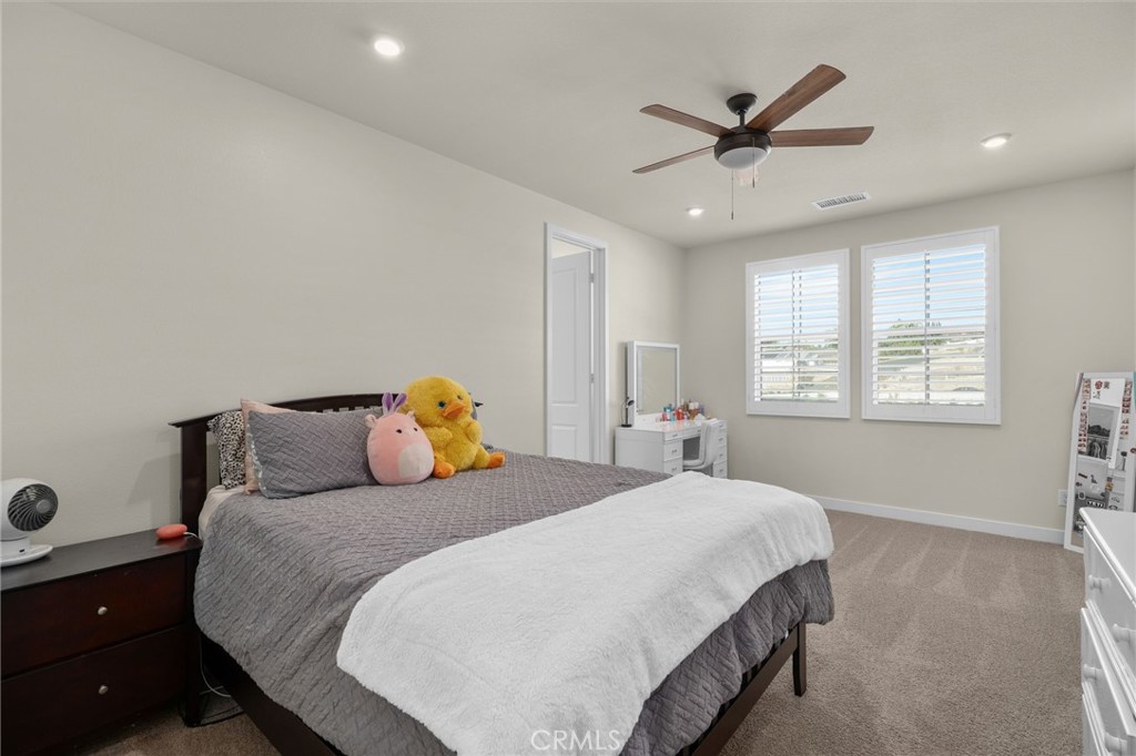 16155 New Canaan Court Riverside, CA 92504 - Photo 22 of 26 a bedroom with a bed and window