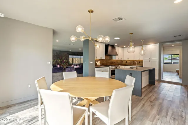 a kitchen with kitchen island a wooden floor and white appliances