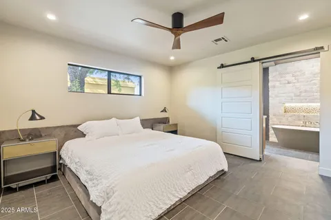 a spacious bathroom with a double vanity sink and a mirror