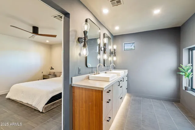 a bathroom with a sink double vanity and a mirror