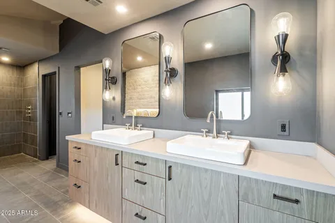 a bathroom with a bathtub sink and mirror