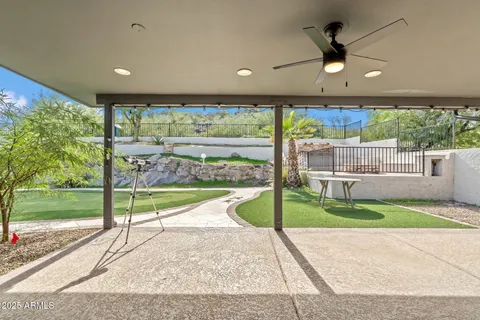 a view of a house with a swimming pool and a yard