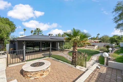 a swimming pool with outdoor seating and yard