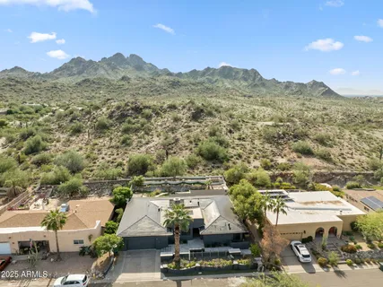 an aerial view of residential houses with outdoor space and trees