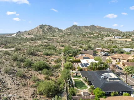 an aerial view of residential houses with outdoor space and street view