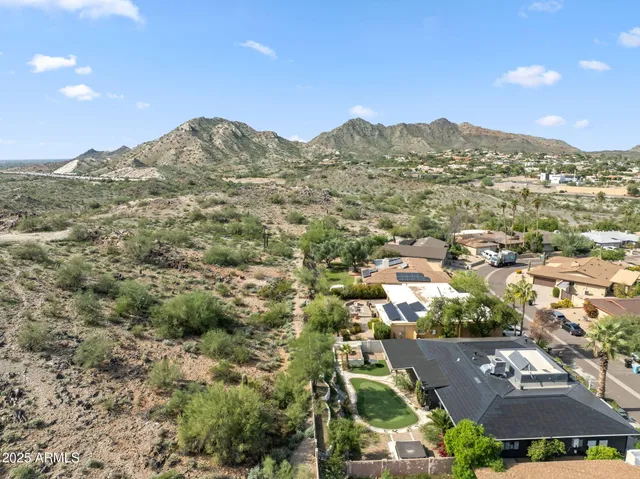 an aerial view of residential houses with outdoor space and street view