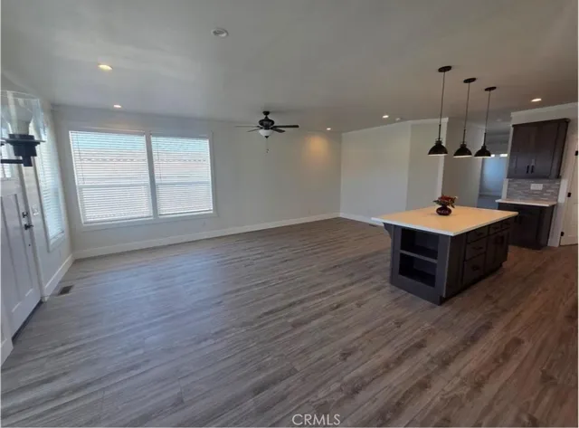 an empty room with wooden floor and a window