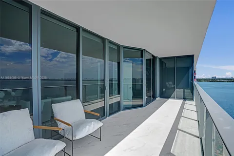 a balcony with table and chairs